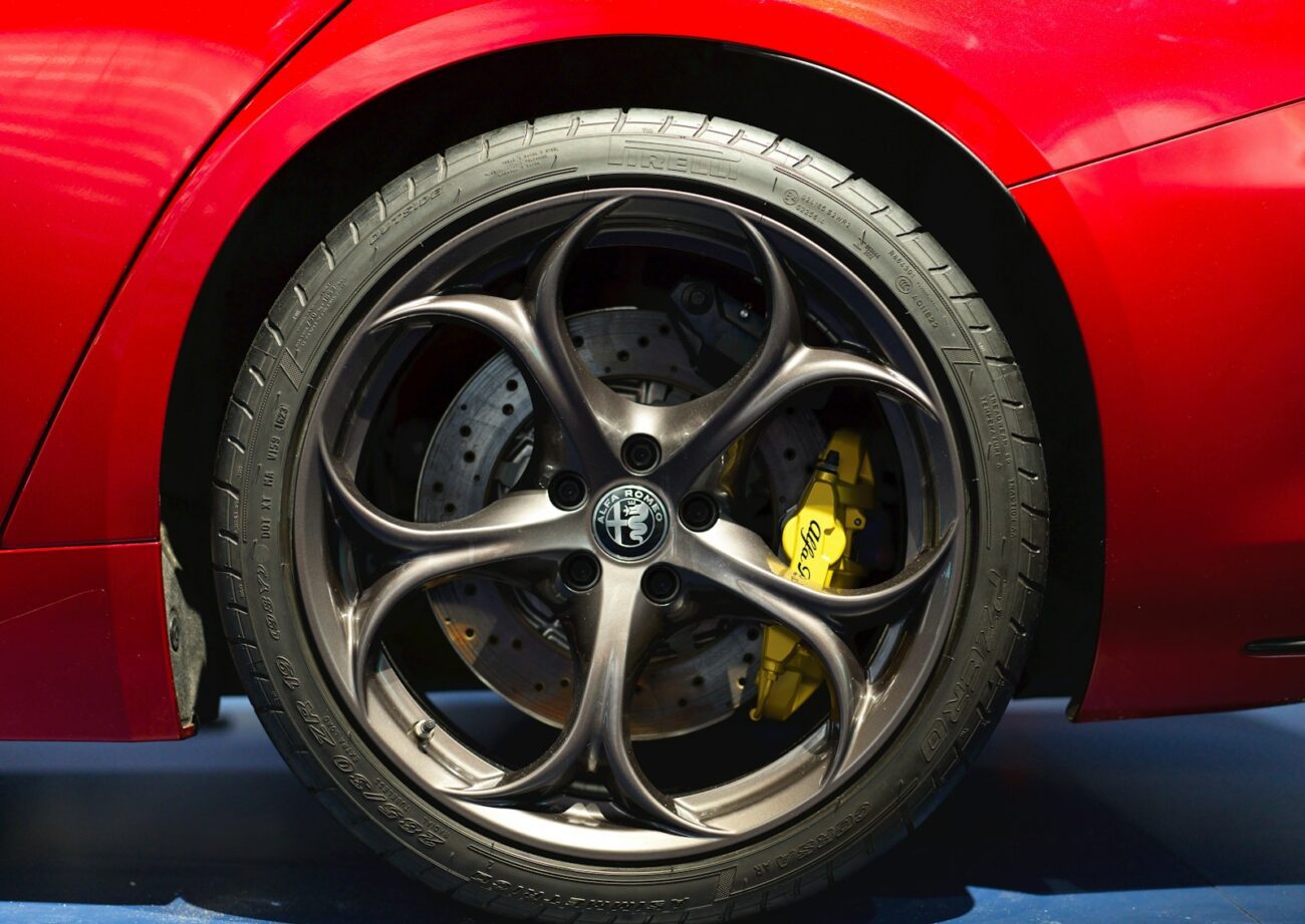 A close up of a red sports car tire